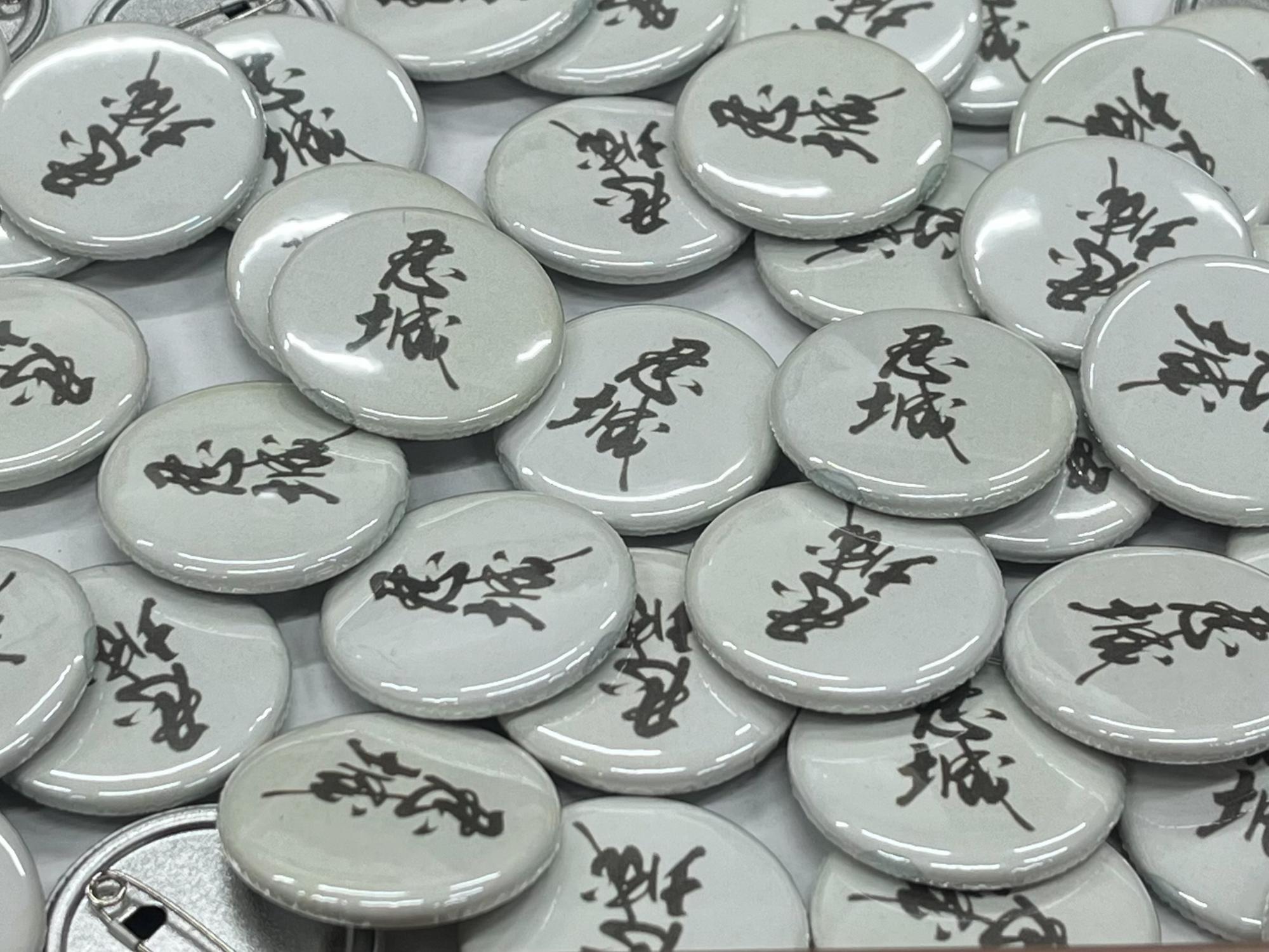 「忍城」の文字をデザインした缶バッジ