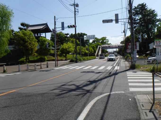 2車線の道路を数台の車が通り、手前には横断歩、奥には歩道橋が見える熊谷羽生線（旧国道125号）の写真